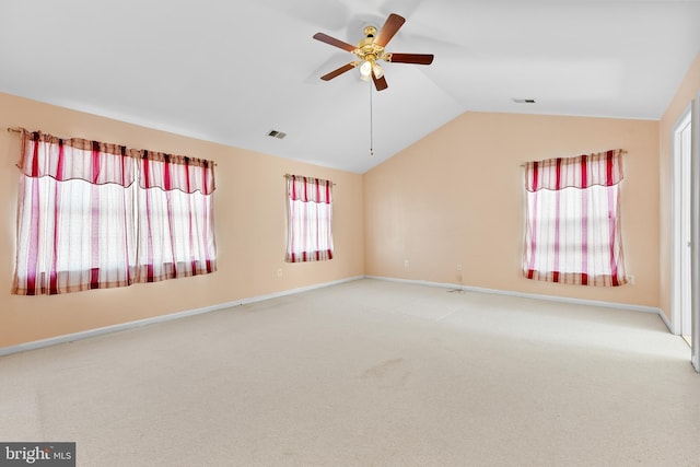 empty room featuring ceiling fan, carpet, and vaulted ceiling