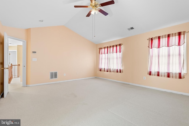 carpeted empty room featuring ceiling fan and vaulted ceiling