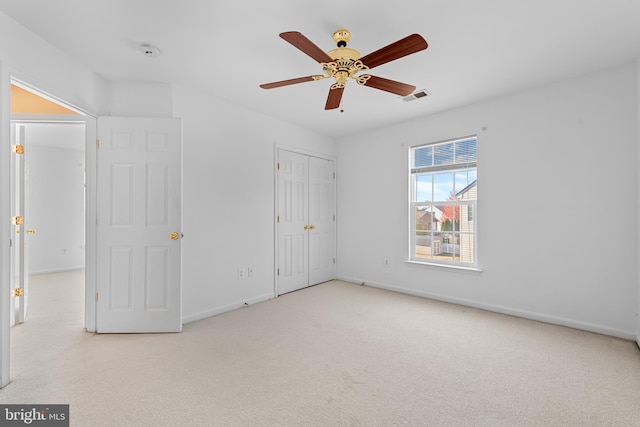 unfurnished bedroom with light carpet and ceiling fan