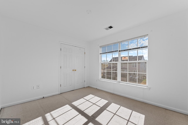 empty room with light colored carpet