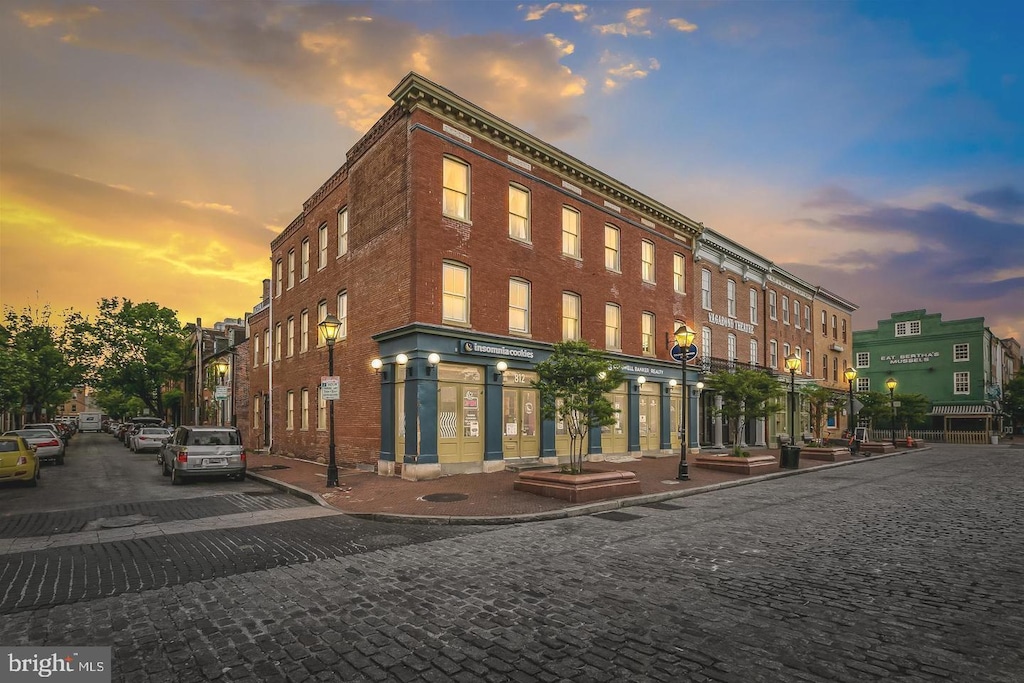 view of outdoor building at dusk