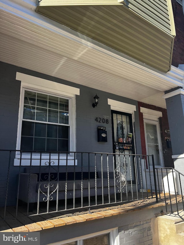 view of exterior entry featuring a porch