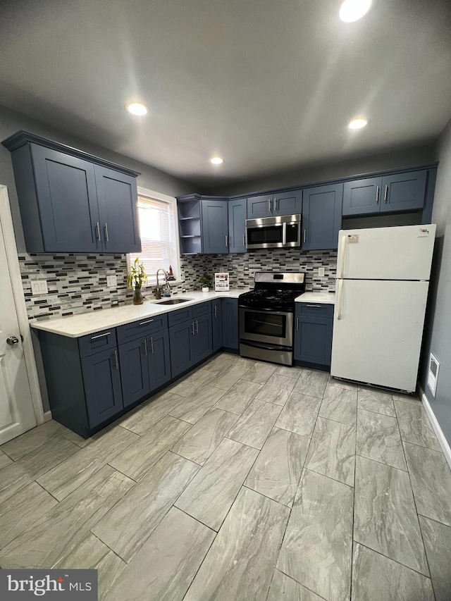 kitchen featuring sink, appliances with stainless steel finishes, and tasteful backsplash