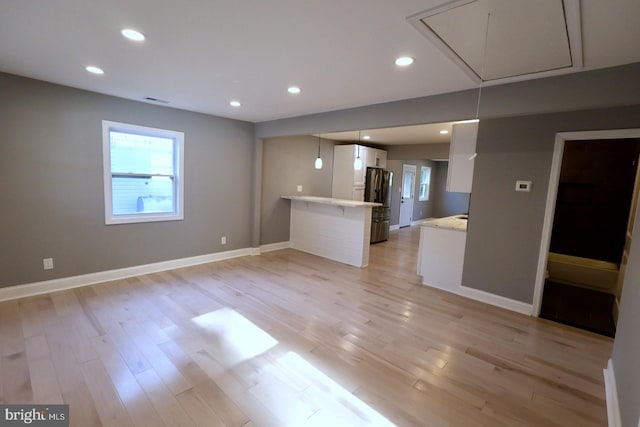 unfurnished living room with light hardwood / wood-style floors