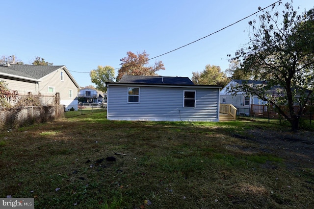 back of house with a lawn