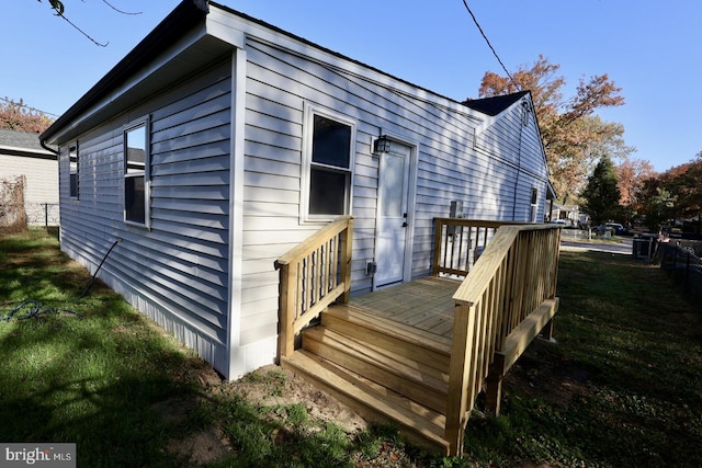 view of property exterior featuring a yard and a deck