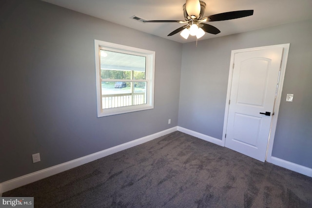 carpeted spare room featuring ceiling fan