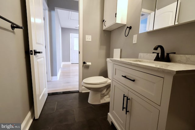 bathroom with vanity, toilet, and tile patterned floors