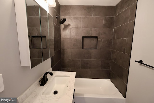 bathroom with vanity and tiled shower / bath combo