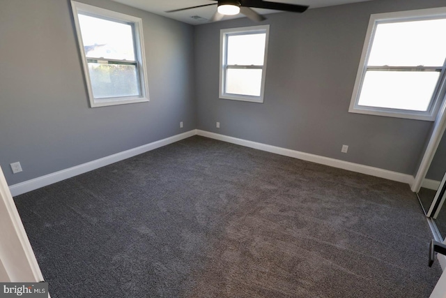 carpeted empty room featuring a healthy amount of sunlight and ceiling fan