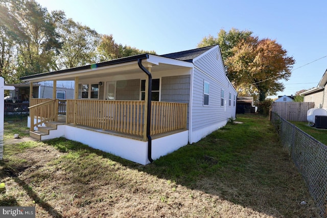 view of front of home with a wooden deck and a front yard