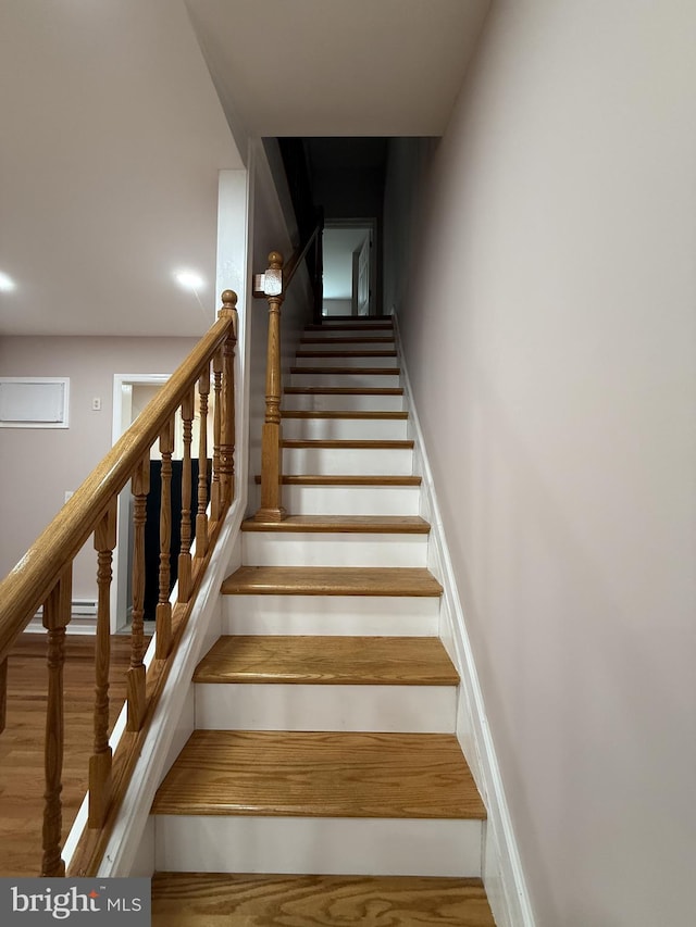 stairs with hardwood / wood-style flooring