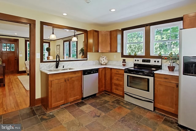 kitchen with sink, dishwasher, white refrigerator with ice dispenser, electric range, and dark wood-type flooring