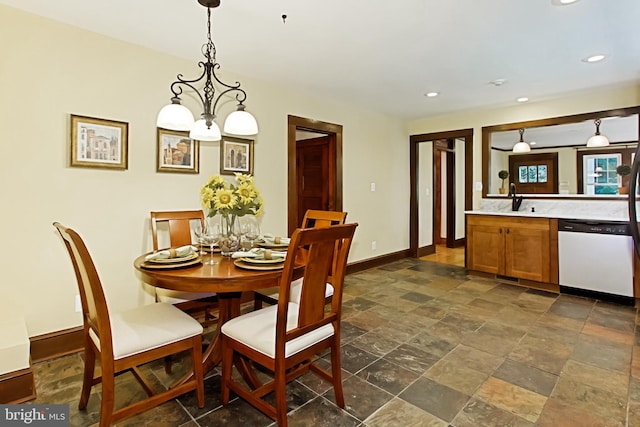 dining room featuring a notable chandelier and sink