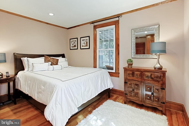 bedroom featuring ornamental molding and hardwood / wood-style floors