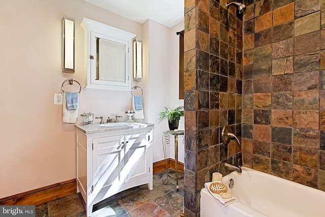 bathroom featuring vanity and tiled shower / bath combo