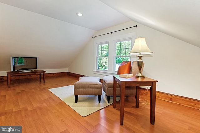 sitting room featuring hardwood / wood-style flooring and lofted ceiling