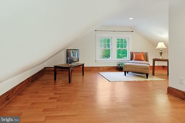 bonus room with vaulted ceiling and light hardwood / wood-style floors