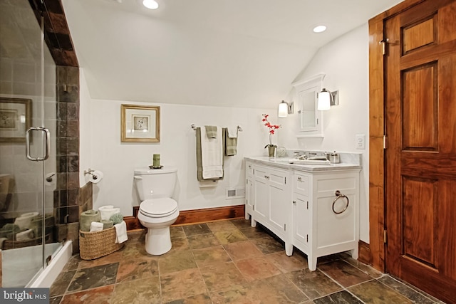 bathroom with toilet, a shower with shower door, vanity, and vaulted ceiling