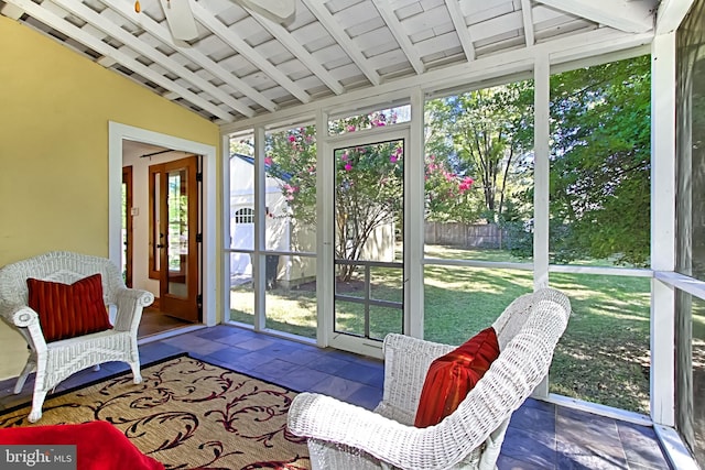 sunroom with lofted ceiling with beams