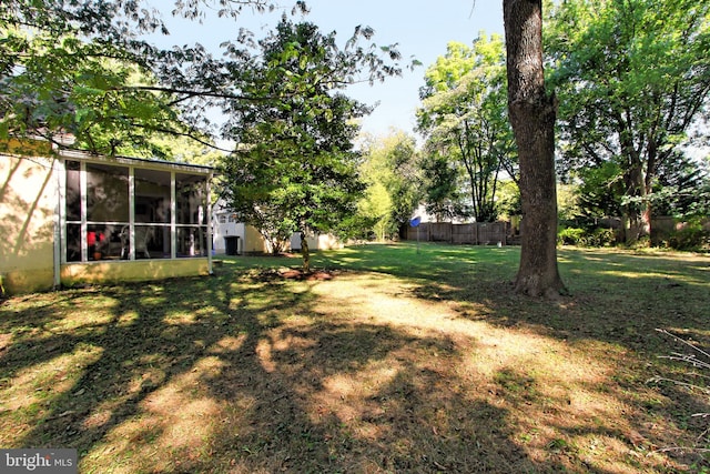 view of yard with a sunroom