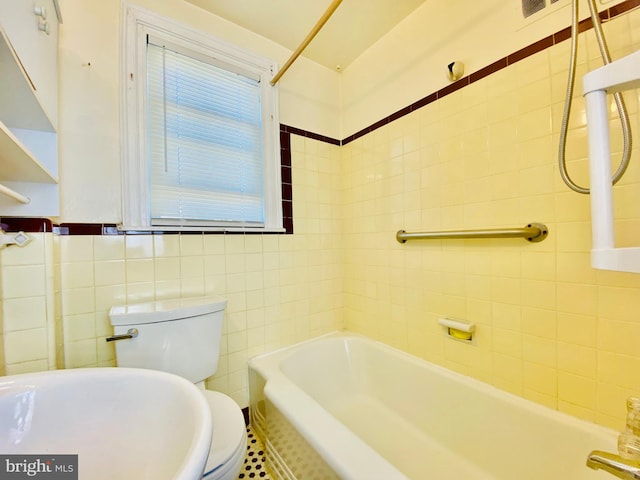 bathroom with tile walls and toilet