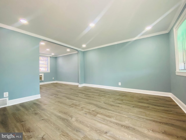 unfurnished room featuring ornamental molding and hardwood / wood-style flooring