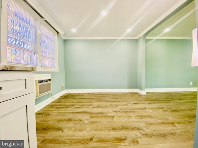 interior space with hardwood / wood-style floors and an AC wall unit