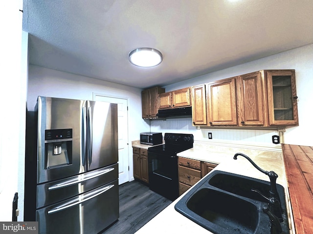 kitchen with dark hardwood / wood-style flooring, sink, and appliances with stainless steel finishes