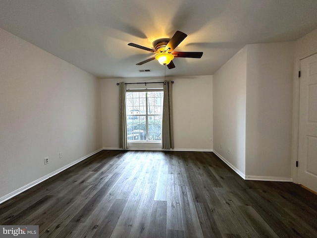 unfurnished room featuring ceiling fan and dark wood-type flooring