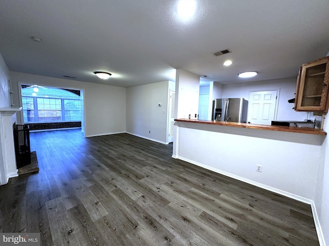 unfurnished living room featuring dark wood-type flooring