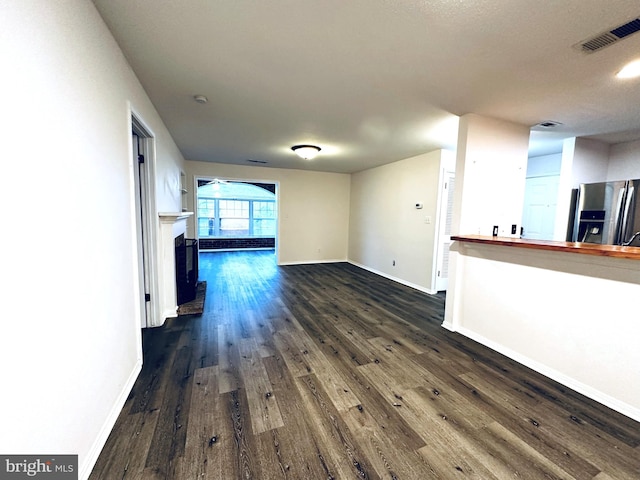 unfurnished living room with dark hardwood / wood-style flooring