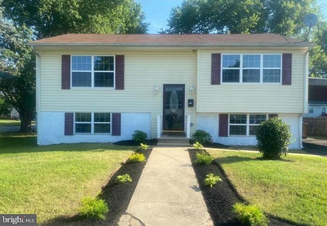 bi-level home with a front lawn