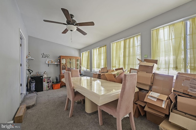 carpeted dining space featuring ceiling fan