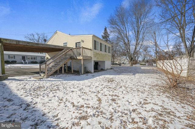 view of snow covered rear of property