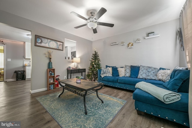 living room with dark hardwood / wood-style floors and ceiling fan