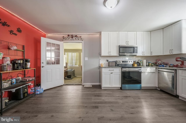 kitchen with white cabinets and appliances with stainless steel finishes