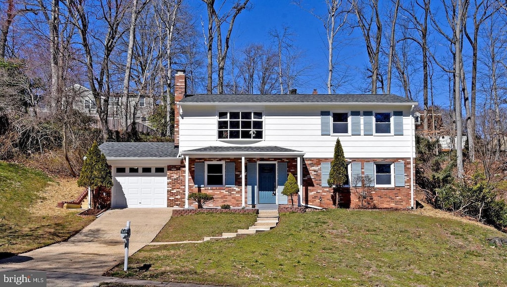 front facade with covered porch, a garage, and a front yard