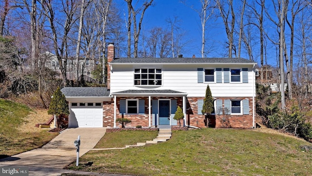 front facade with covered porch, a garage, and a front yard