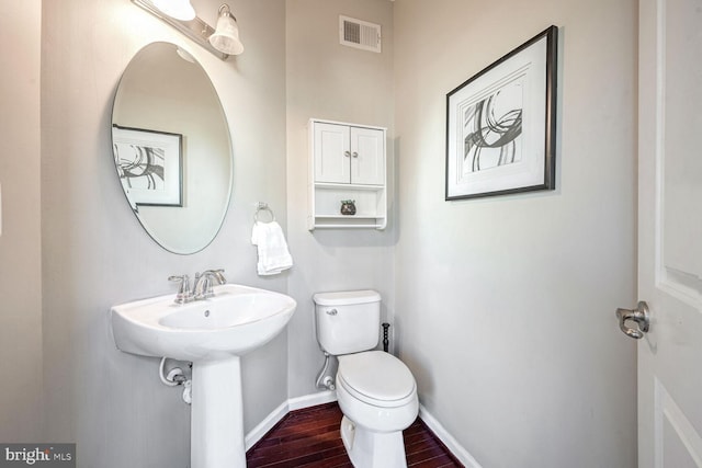 bathroom with sink, hardwood / wood-style floors, and toilet