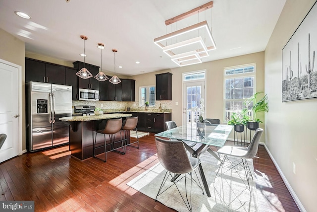 dining area with dark hardwood / wood-style flooring