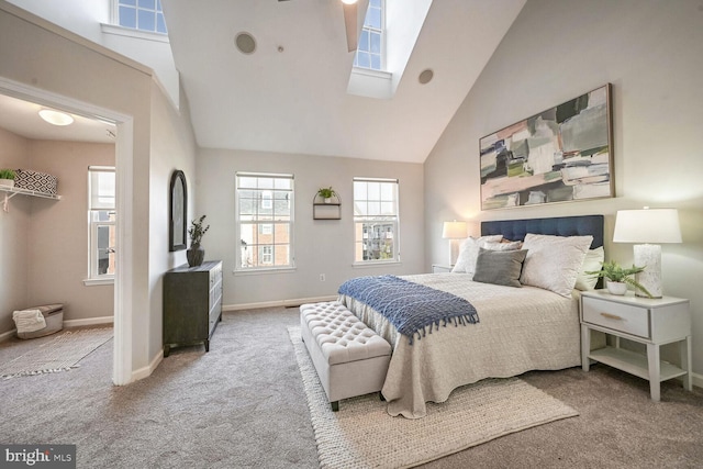 carpeted bedroom featuring high vaulted ceiling