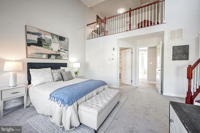 bedroom featuring carpet and high vaulted ceiling