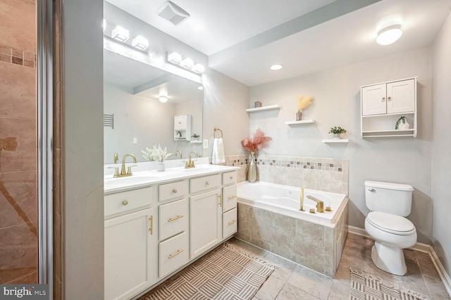 bathroom with tile patterned flooring, vanity, toilet, and tiled tub