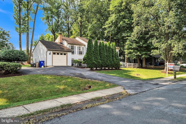 bi-level home with a front yard and a garage