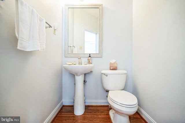 bathroom with toilet and hardwood / wood-style floors