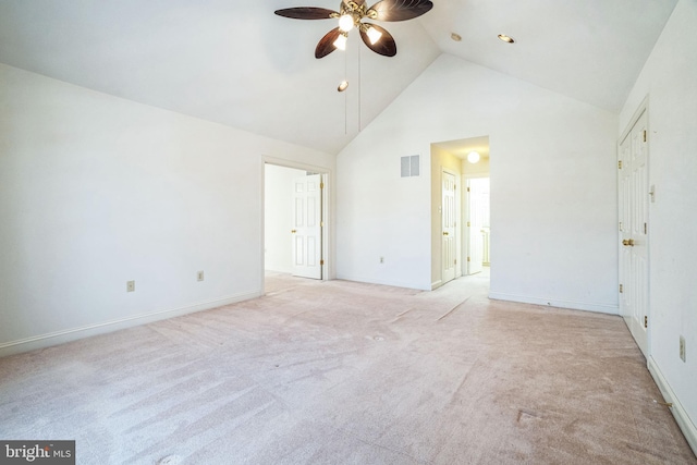 carpeted spare room featuring ceiling fan and high vaulted ceiling