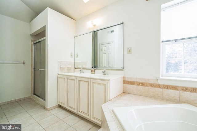 bathroom with tile patterned flooring, separate shower and tub, and vanity