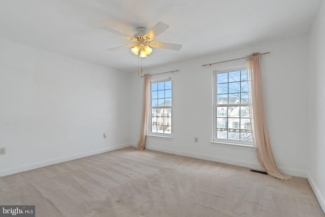 unfurnished room with ceiling fan and light colored carpet