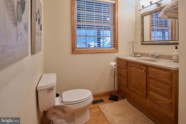 bathroom featuring vanity, hardwood / wood-style floors, and toilet